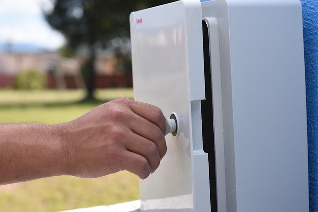 Close-up photo of an electrical box extender being screwed into a metal electrical box, flush with new tile