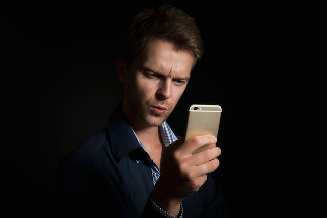 person using a tack cloth to wipe dust from wood after sanding